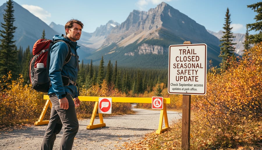 Hiker standing beside a closed trail area sign near a forested path in Banff
